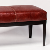 Banqueta cuero Caoba, medidas 120 x 40 x 45 cms. Estructura perfil hierro negro.